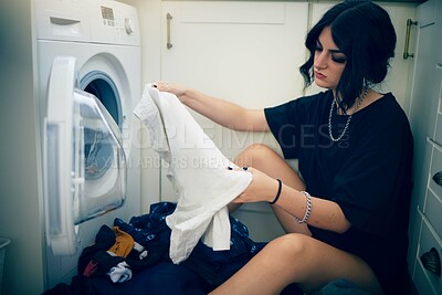 Buy stock photo Laundry, cleaning and housework with a woman using the washing machine in her home for domestic responsbility. Appliance, fabric and clothes with a female cleaner on her apartment floor to wash