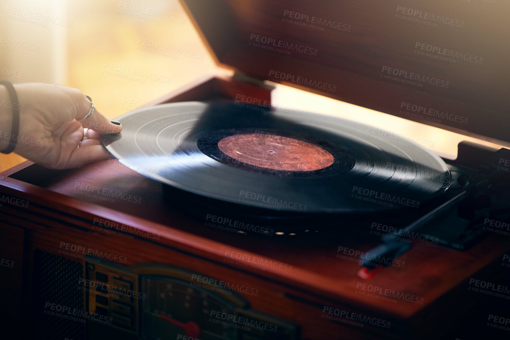 Buy stock photo Record player, hand and woman playing music in home living room. Classic technology, retro and female putting vintage vinyl record in turntable or gramophone to play sound, audio or song in house.