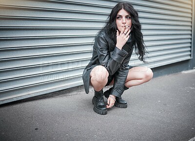 Buy stock photo Punk, emo and woman smoking a cigarette in the street of an urban city in Canada in an edgy black outfit. Grunge, rocker and girl smoker with tobacco to smoke while sitting in the road in town. 