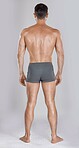 Man, body muscles and back on studio background for fitness check, workout training goals or exercise wellness power. Model, bodybuilder and strong athlete on gray backdrop for healthcare gym target