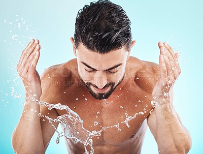 Buy stock photo Skincare, water splash and man in a studio for a wellness, health and self care body routine. Cosmetics, hydration and male model with natural dermatology facial treatment isolated by blue background