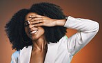 Black woman, hand with manicure and face with beauty,
hair with hair care and happy with afro against studio background. Makeup cosmetic, nails and skincare with facial and natural curly hair texture