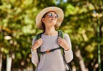 Sunglasses, woman thinking and adventure, outdoor and walking for wellness, fitness and break. Happiness, female tourist and lady in nature, travel and getaway for calm, healthy lifestyle and tourism