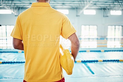 Buy stock photo Security, safety or lifeguard by a swimming pool to help rescue the public from danger or drowning in water. Back view, trust or man standing with a lifebuoy ready with reliable assistance or support