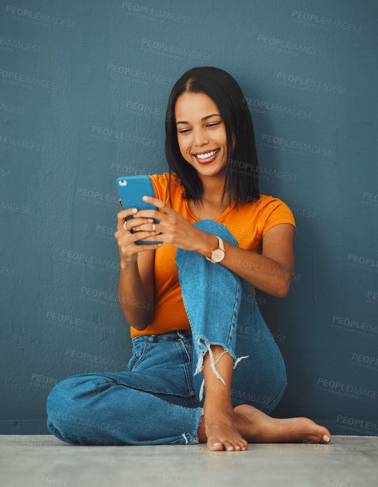 Buy stock photo Happiness, black woman on floor and smartphone for connection, smile and communication on dark studio background. Female, lady and cellphone for typing, texting and social media for online reading