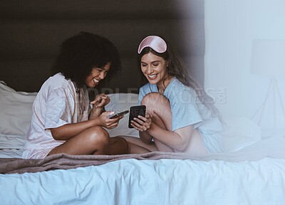 Buy stock photo Woman, friends and phone with smile for social media, networking or funny meme on bed together at home. Happy women smiling, laughing and relaxing for post or smartphone entertainment in the bedroom
