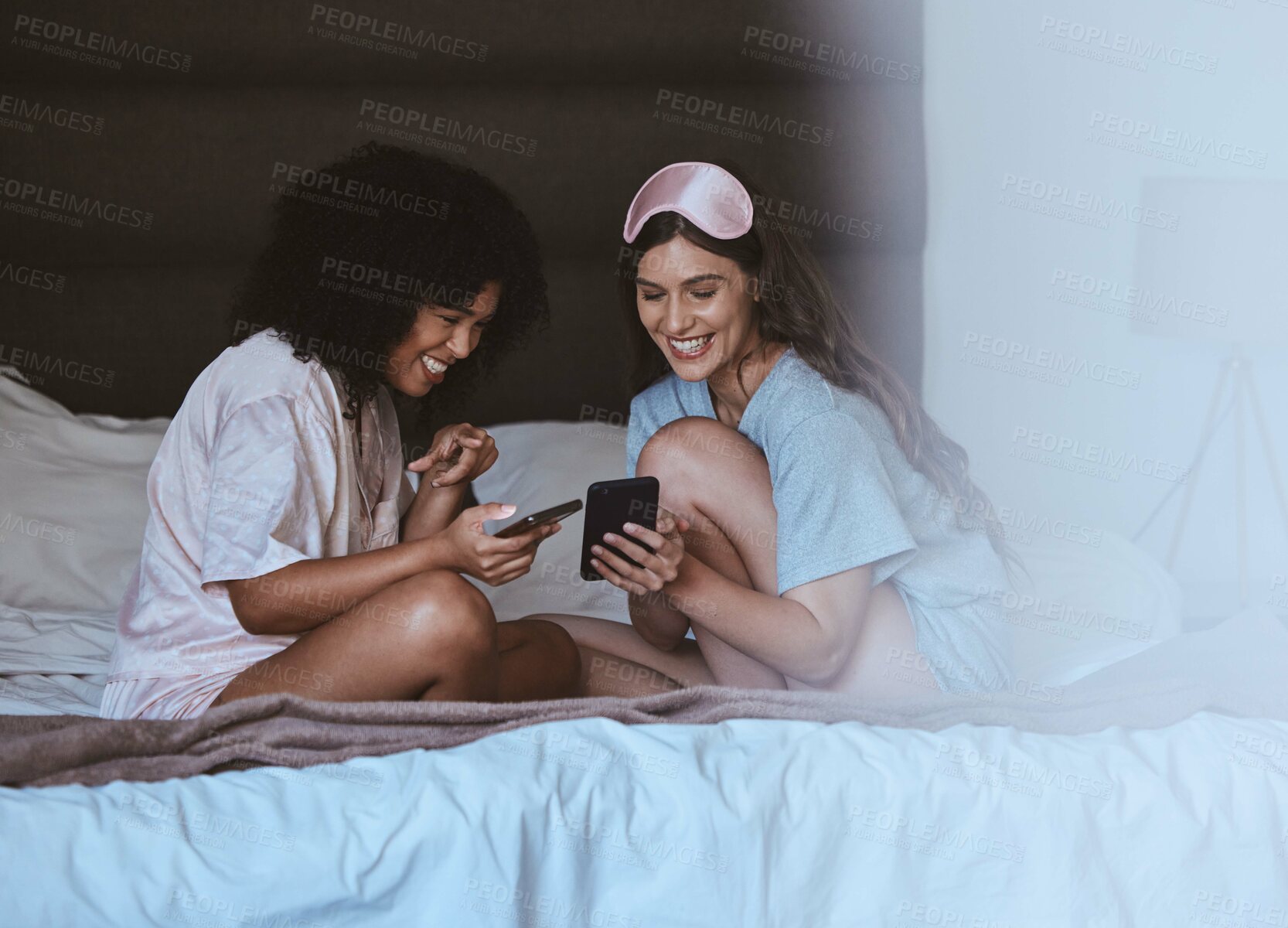 Buy stock photo Woman, friends and phone with smile for social media, networking or funny meme on bed together at home. Happy women smiling, laughing and relaxing for post or smartphone entertainment in the bedroom