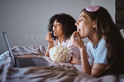 Buy stock photo Laptop, movie and relax with friends and popcorn in bedroom for sleepover, bonding and streaming. Technology, internet and online with women at night for cinema, subscription and film entertainment