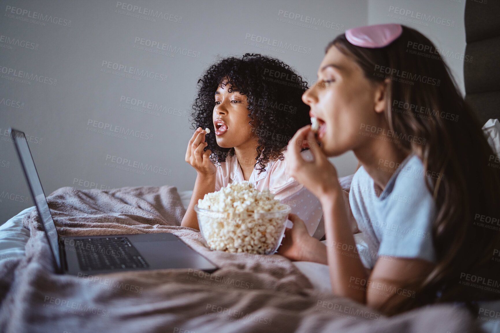 Buy stock photo Laptop, movie and relax with friends and popcorn in bedroom for sleepover, bonding and streaming. Technology, internet and online with women at night for cinema, subscription and film entertainment