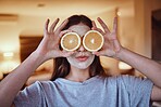 Orange, eyes and skincare facial for woman in a bedroom, grooming and having fun with skin treatment. Face, mask and girl relax with fruit product, hygiene and beauty routine, satisfied and at home