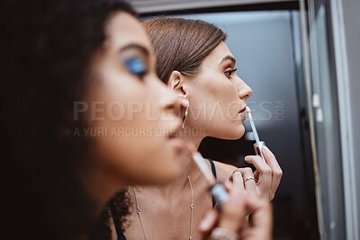 Buy stock photo Women, friends and makeup at mirror in bathroom for beauty, diversity or cosmetics in night together. Black woman, girl and model with lipstick, dark aesthetic and creativity for cosmetic application