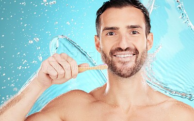 Buy stock photo Eco friendly toothbrush, water and portrait of man on blue background for wellness, hygiene and brushing teeth. Cleaning, dental and face of male with toothpaste for grooming, whitening and health