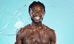 Water splash, beauty and black man isolated on blue background for face cleaning, body shower and skincare. Strong, muscle and happy model or person facial glow in studio headshot washing or hygiene