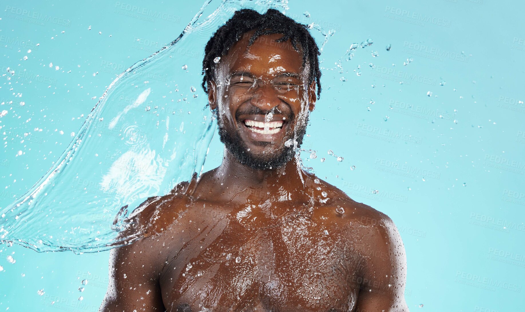 Buy stock photo Water splash, beauty and black man isolated on blue background for face cleaning, body shower and skincare. Strong, muscle and happy model or person facial glow in studio headshot washing or hygiene