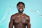 Water splash, portrait and black man isolated on blue background for face cleaning, body shower and skincare. Strong, beauty and happy model or person muscle with studio headshot, washing or hygiene