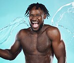 Water splash, black man and body with shower, happiness and surprise with skincare isolated on blue background.
Excited, clean skin and natural cosmetics with grooming, hygiene and beauty in studio