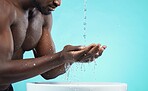 Water drops, black man and cleaning hands with skin, washing face and skincare isolated on blue background. Mockup space, clean body and natural cosmetics with grooming, hygiene and beauty in studio