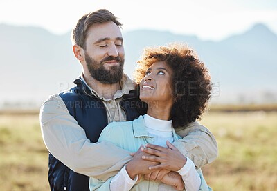Buy stock photo Love, happy and hug with interracial couple on farm for agriculture, peace and growth. Teamwork, countryside and nature with man and black woman in grass field for sustainability, agro or environment
