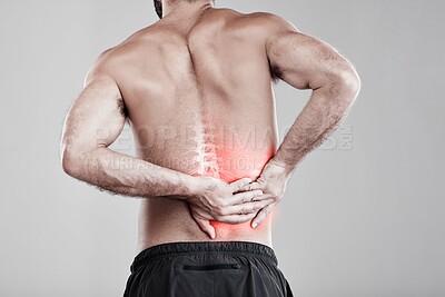 Buy stock photo Man, hands and back pain in x ray for injury, bruise or spinal ache against a gray studio background. Male model suffering from broken spine, inflammation or muscle holding painful bone or area