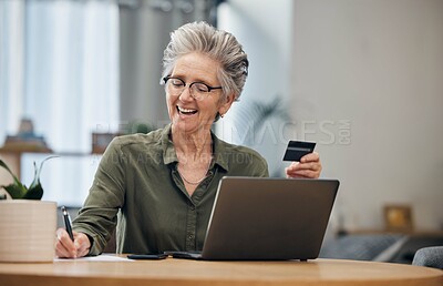 Buy stock photo Laptop, credit card and senior woman paying her bills, debt or mortgage with online banking. Elderly lady planning a financial investment or calculating her retirement finances on paper at her home.