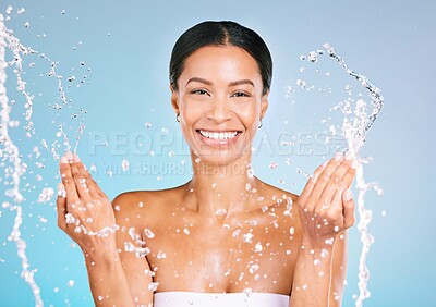 Buy stock photo Portrait, black woman and water for cleaning, dermatology and smile with wellness, health and blue studio background. Face detox, African American female and happy lady with liquid, aqua and skincare