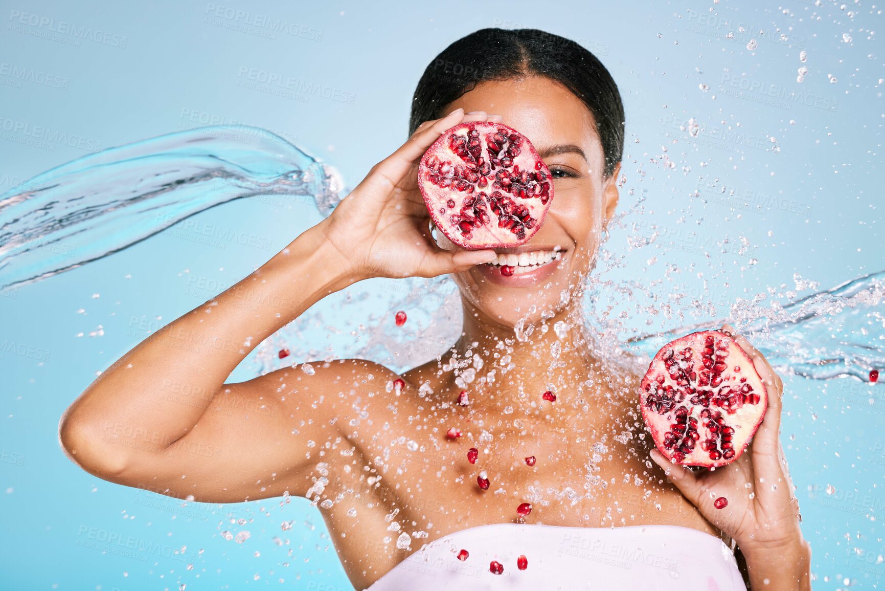 Buy stock photo Pomegranate, skincare and woman portrait with beauty and healthy skin or diet on blue background. Face of aesthetic model person with water splash and fruit for sustainable facial health and wellness