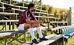 Rugby, sports or black man on pavilion thinking of training, exercise or workout match on grass field. Wellness, focus or African athlete with a vision, motivation or fitness goals sitting on a bench