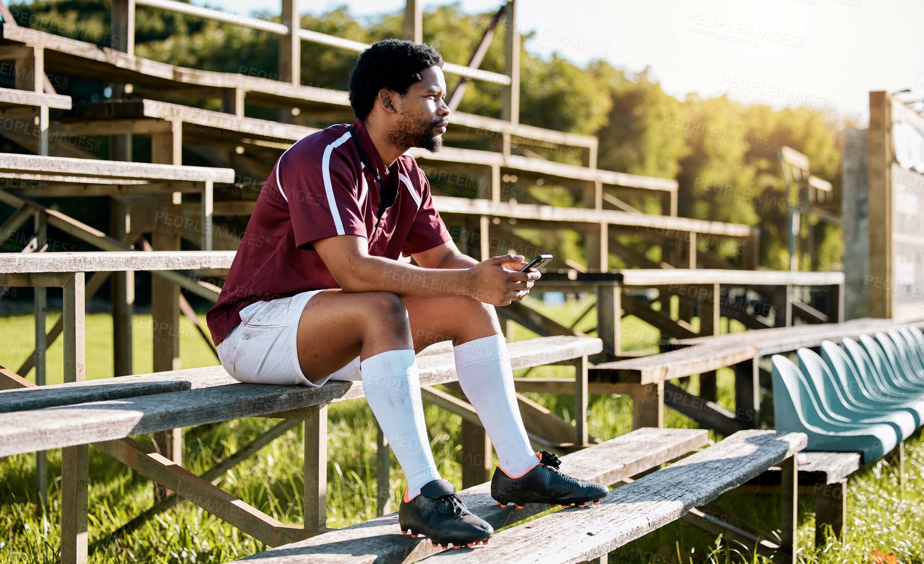 Buy stock photo Rugby, sports or black man on pavilion thinking of training, exercise or workout game on grass field. Wellness, focus or African athlete with a vision, motivation or fitness goals sitting on a bench