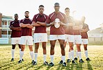 Rugby, grass and portrait of men, team with ball and standing together with confidence for winning game. Diversity, black man and group of strong sports people in leadership, fitness and teamwork.