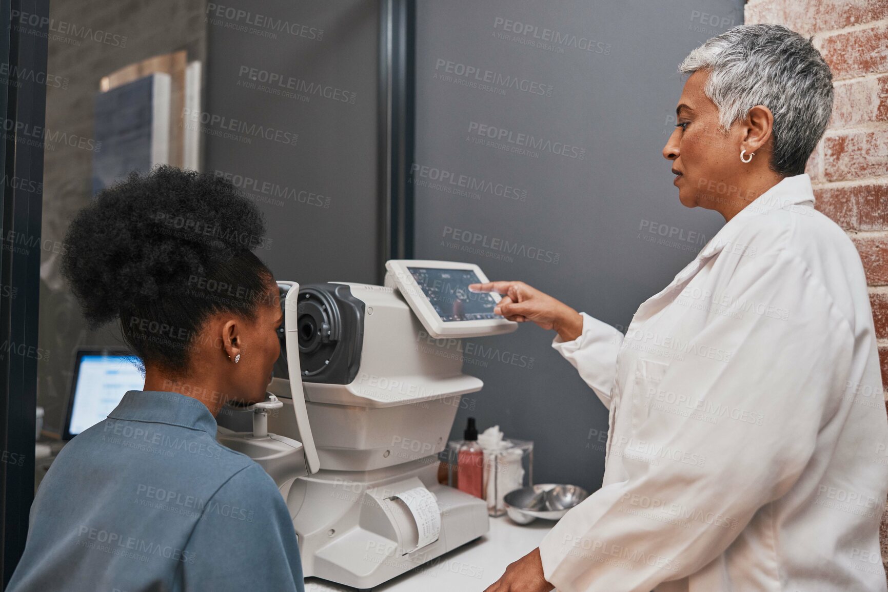 Buy stock photo Digital eye exam, vision and health for eyes, optometry and doctor with patient, eyecare and ophthalmology clinic. Machine, screen and black woman with senior optometrist, service and medical exam