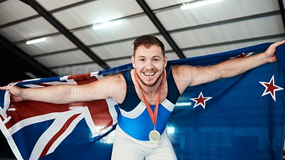 Buy stock photo Man, athlete and flag on shoulder with medal, smile and sports for portrait, competition and pride. New Zealand champion, happy and winner with gold, celebrate or success in global gymnastics contest
