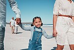 Mother, father and girl holding hands by the beach to relax on summer holiday, vacation and weekend. Happy family, travel and portrait of child with mom and dad for fun, bonding and quality time