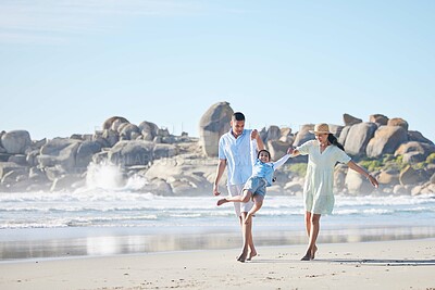 Buy stock photo Family, parents and swinging a child at the beach for fun, adventure and play on holiday. A happy woman, man and young kid walking on sand and holding hands on vacation at ocean, nature or outdoor