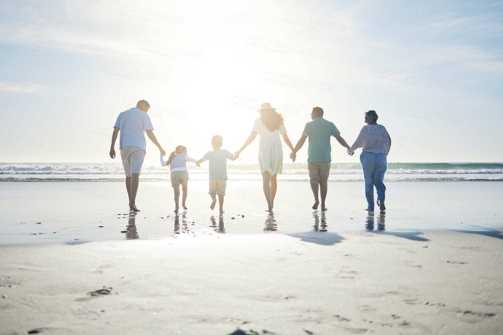Buy stock photo Beach, holding hands and grandparents, parents and kids for bonding, quality time and relax in nature. Family, travel and back of mom, dad and children walking on holiday, vacation and adventure