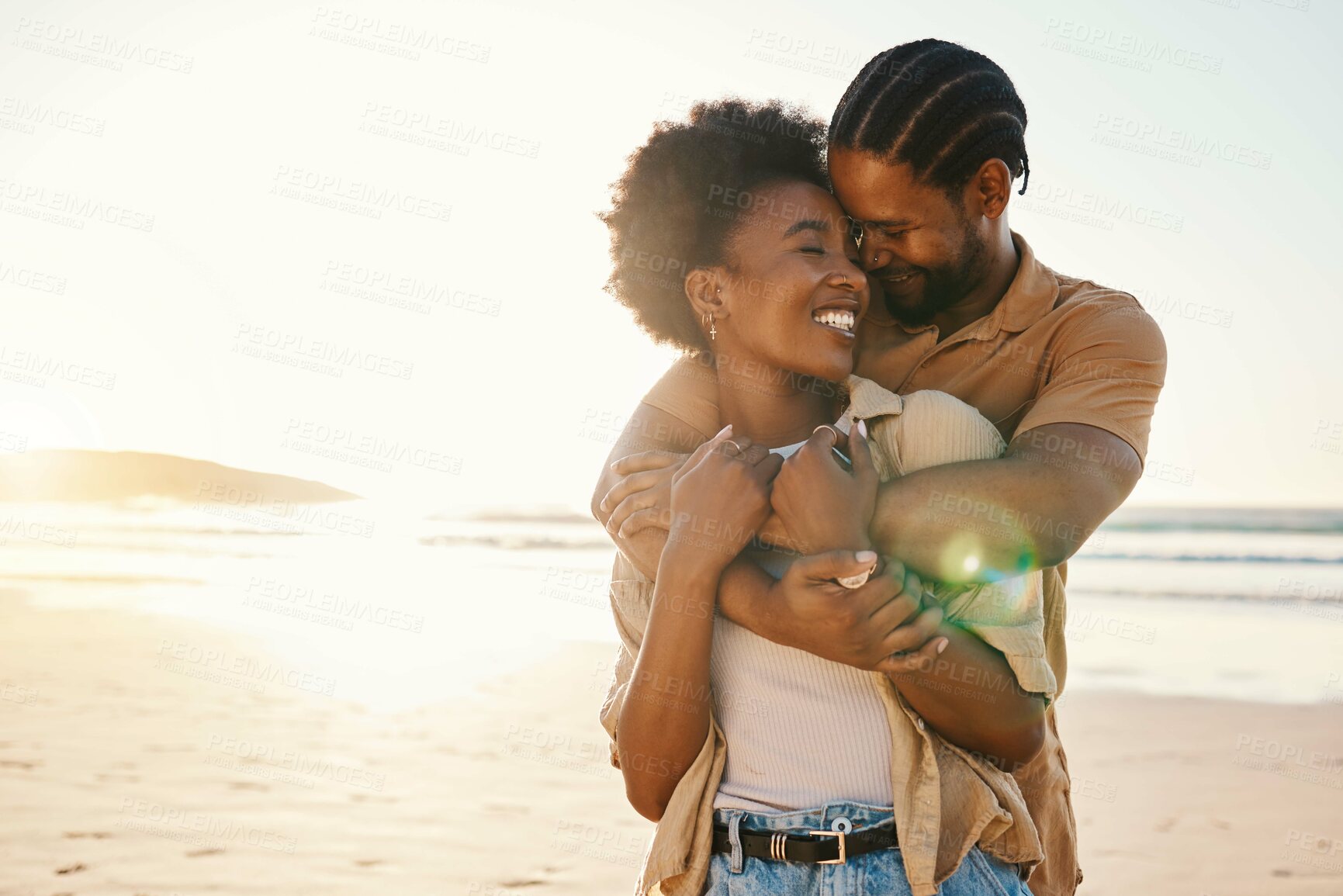 Buy stock photo Beach sunset, love and happy black couple hug, sunshine and enjoy bonding time together on romantic Nigeria date. Marriage honeymoon, lens flare or hugging African people connect on anniversary break