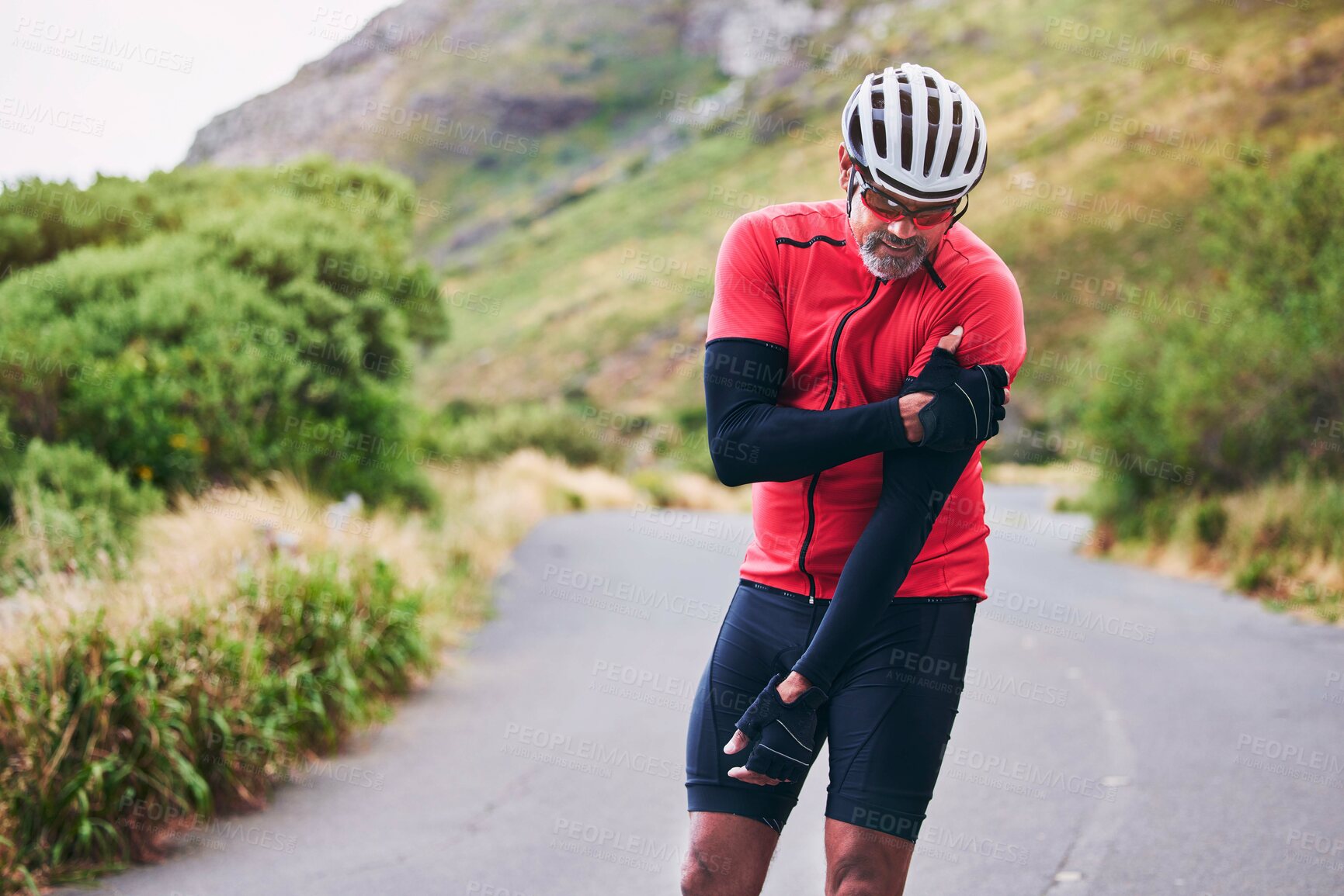 Buy stock photo Man, cyclist and arm injury in fitness accident, emergency or broken bone on mountain road in nature. Male person or athlete with sore pain, ache or inflammation on joint in sports fall or cycling