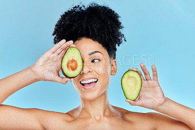 Buy stock photo Happy woman, face and avocado for natural skincare, beauty or diet against a blue studio background. Female person or model smile with organic vegetable for nutrition, vitamin C or skin wellness