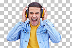 Headphones, man and screaming portrait on background, pink wall backdrop or studio mockup. Crazy guy listening to music, shouting and loud volume for streaming media with sound, audio hearing or face