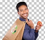 Man in portrait, happy and recycling paper bag with tomato and sustainable shopping on studio background. Eco friendly, vegetable and climate change awareness in retail, sustainability and health