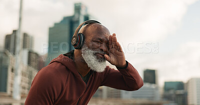 Buy stock photo Senior, fitness and tired man in a city with music headphones for intense, cardio or training outdoor Sport, fatigue and elderly male runner stop for break, breathe and sweating from running workout