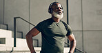 Mature, black man and exercise with headphones for fitness, workout and runner rest for breathing outdoor on stairs. Thinking, training and athlete listening to music, podcast or radio for motivation