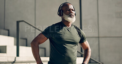 Buy stock photo Mature, black man and exercise with headphones for fitness, workout and runner rest for breathing outdoor on stairs. Thinking, training and athlete listening to music, podcast or radio for motivation