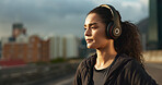 Woman, runner and headphones in city for fitness in evening sunset, music playlist workout motivation. Female person, listen and training thinking on street for cardio audio, exercise or streaming
