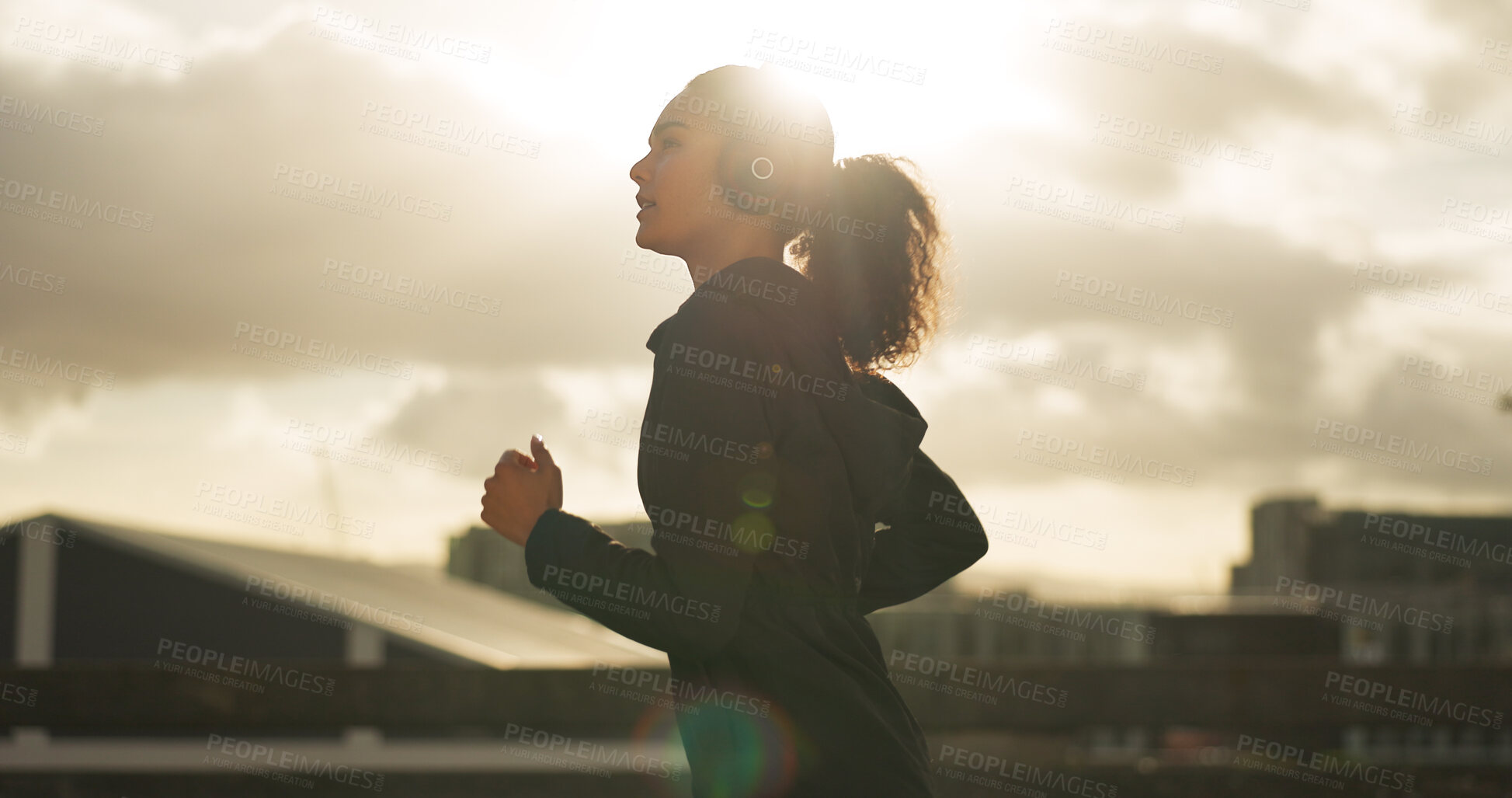 Buy stock photo Woman, morning and running in city with headphones for fitness, workout and marathon training music. Sun lens flare, athlete or exercise podcast in Brazil for cardio wellness, health or sports radio