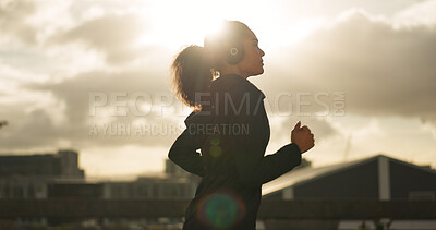 Buy stock photo Athlete, morning and running in city with headphones for fitness, workout and marathon training music. Sun lens flare, woman or exercise podcast in Brazil for cardio wellness, clouds or sports radio