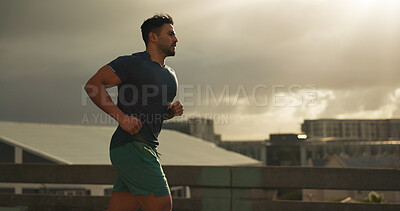 Buy stock photo Running, city or man athlete in workout by training, cardio jog or fitness goals for marathon competition. Indian runner, wellness or progress in race, exercise or strong health body on urban road 