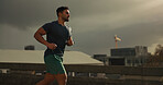 Running, city or man with workout in training, cardio jog or fitness goals for marathon competition. Young athlete, wellness or strong body for france race with progress, road or health lifestyle 