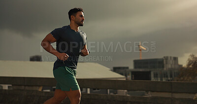 Buy stock photo Running, city or man with workout in training, cardio jog or fitness for marathon competition. athlete, wellness or strong body for france with progress, road or health lifestyle and overcast sky