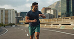 Running, road or man for time in training, practice or fitness goals for marathon competition. Indian athlete, wellness or speed runner in cape town race in watch progress, city street or health body