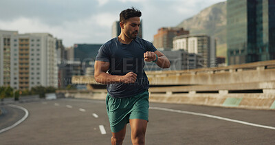 Buy stock photo Running, road or man for time in training, practice or fitness goals for marathon competition. Indian athlete, wellness or speed runner in cape town race in watch progress, city street or health body